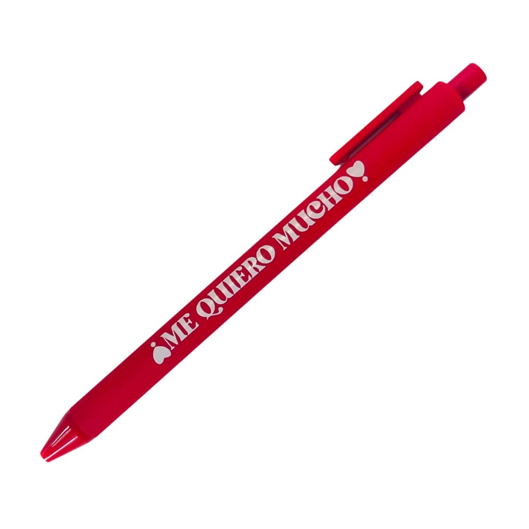 Red pen with the phrase Me Quiero Mucho in white lettering