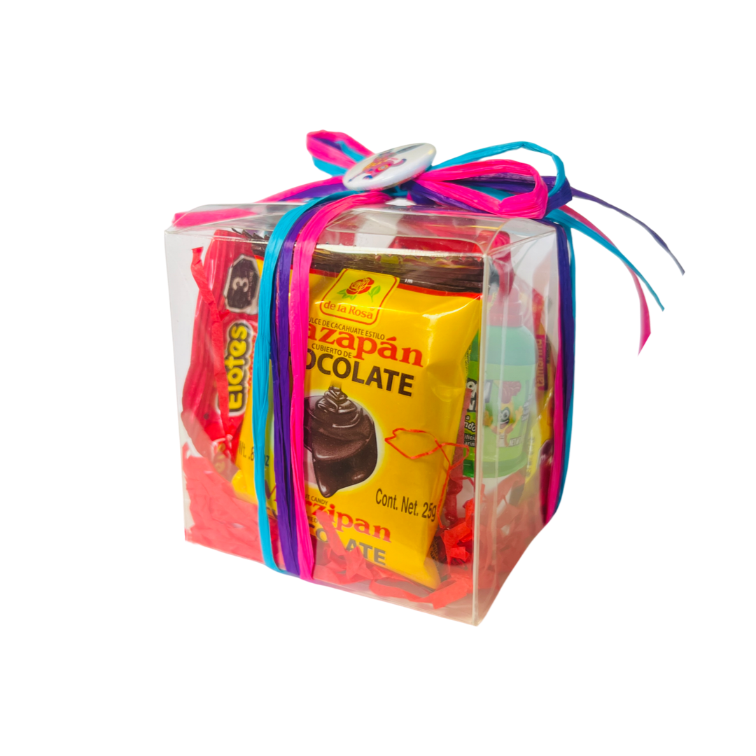 Clear box filled with Mexican candy, red tissue paper and tied with colorful ribbon and a pin-button.