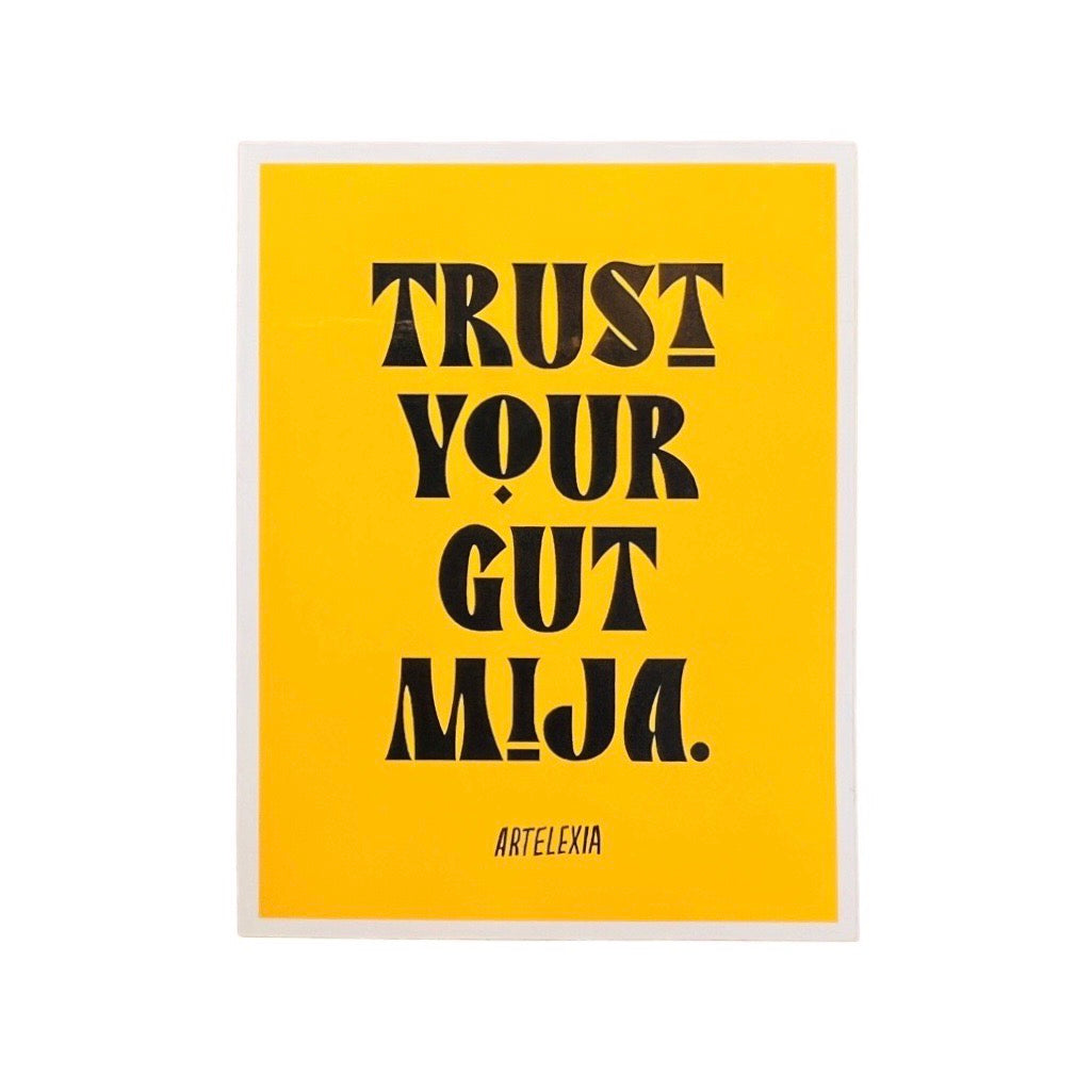 Yellow rectangle with the phrase Trust Your Gut Mija in black lettering