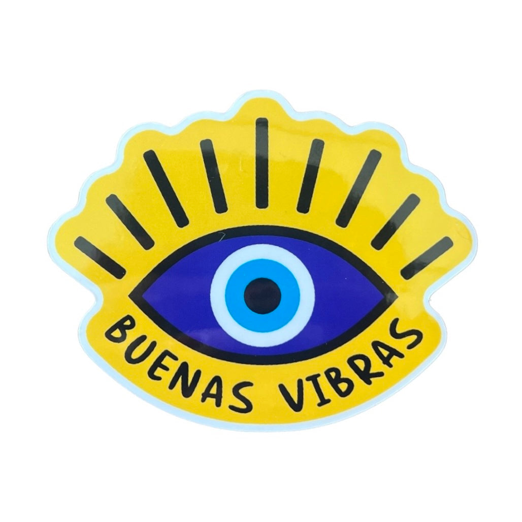 Yellow sticker with a blue and black eye with lashes and the phrase buenas vebras in black lettering
