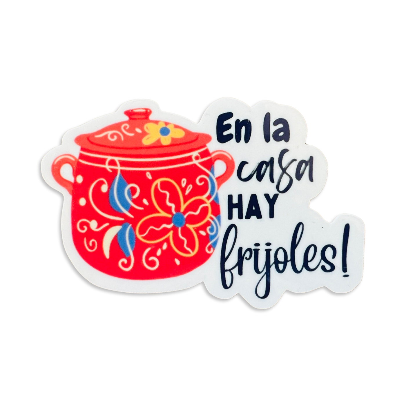 Colorful Mexican cooking pot with a floral design and the phrase En La Casa Hey Frijoles in black lettering.