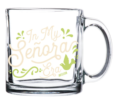 Clear glass mug with the phrase In My Senora Era in cream lettering and light green filagree