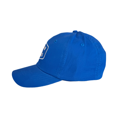 side view of a blue hat with the phrase Juan Of A Kind in white lettering.