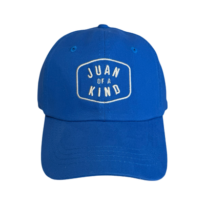 front view of a blue hat with the phrase Juan Of A Kind in white lettering.