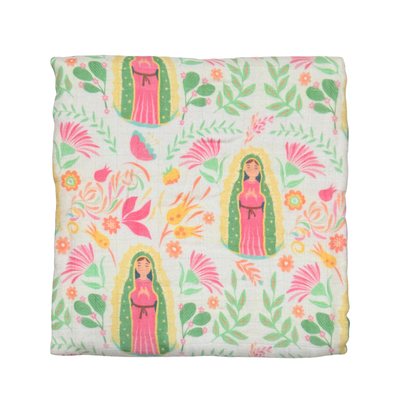 Cream quilt with images of Our Lady of Guadalupe with a pink, green and yellow floral design.