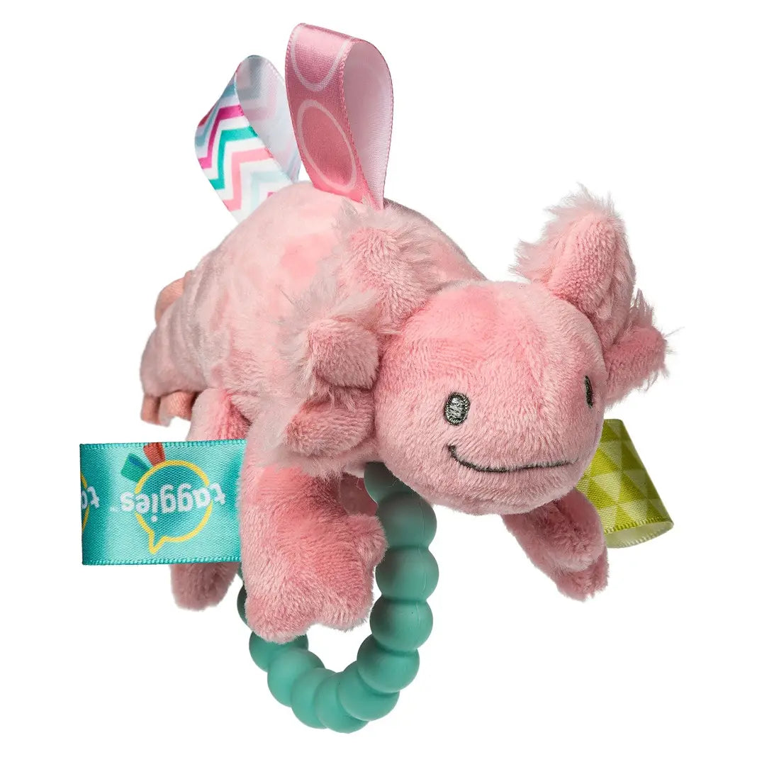 Pink plush axolotl toy with a smiling face, colorful satin tag loops, and a beaded teal teether ring, shown on a white background.