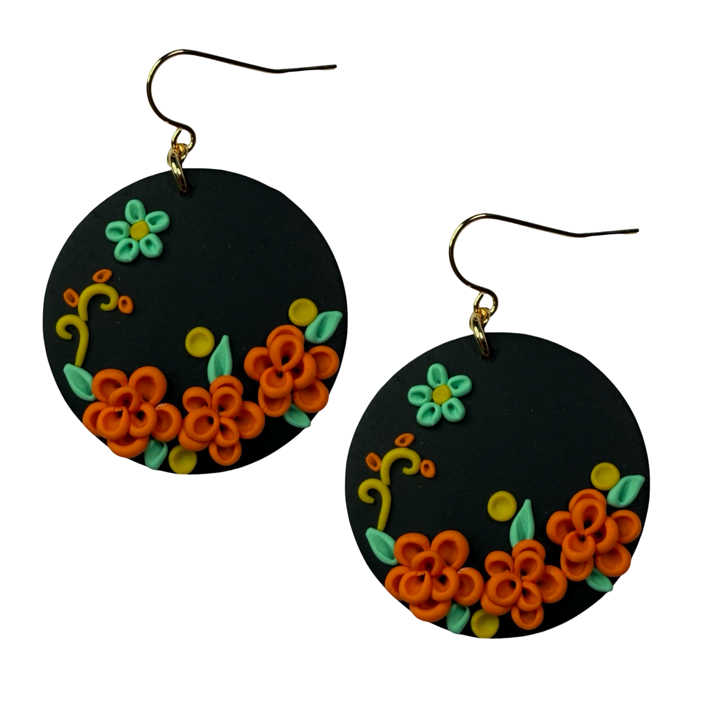 Black earrings with floral designs in orange, green, and yellow