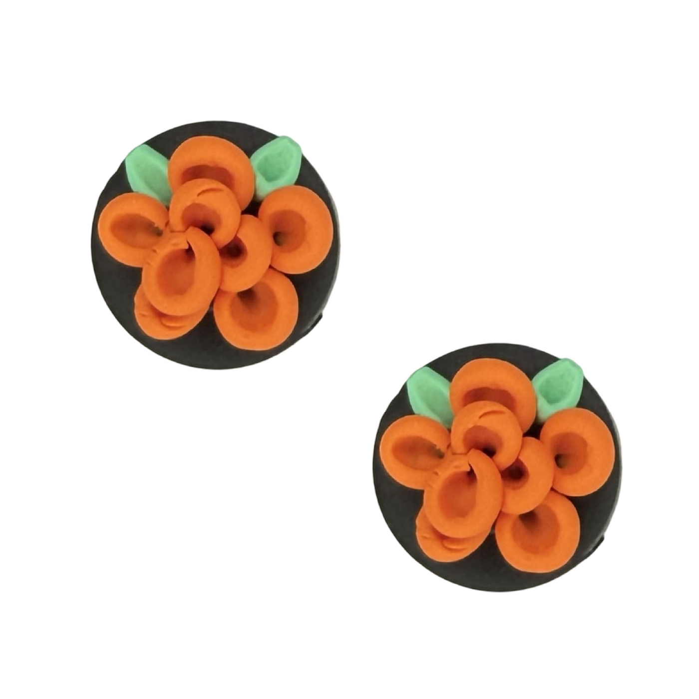 Pair of round earrings with orange floral designs on a black background