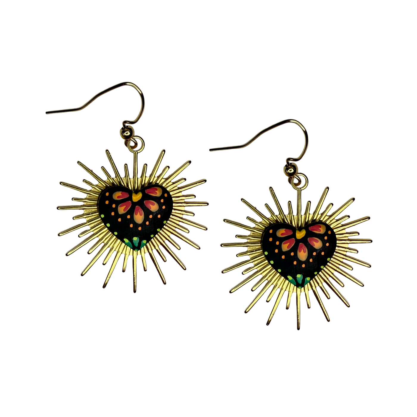 Handmade earrings with black heart centers painted with pink and green floral designs, surrounded by golden rays in the style of Mexican sacred heart folk art.