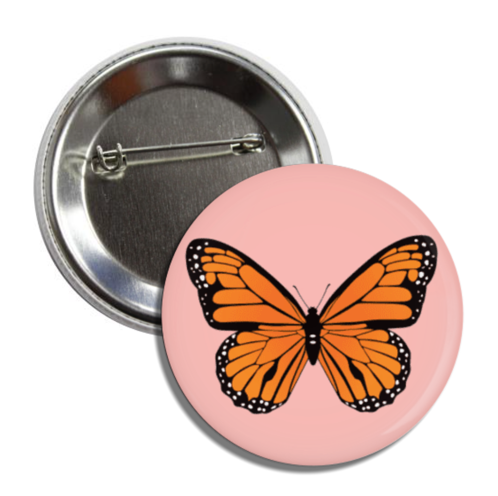 Round pin back button with a pink background and features a monarch butterfly