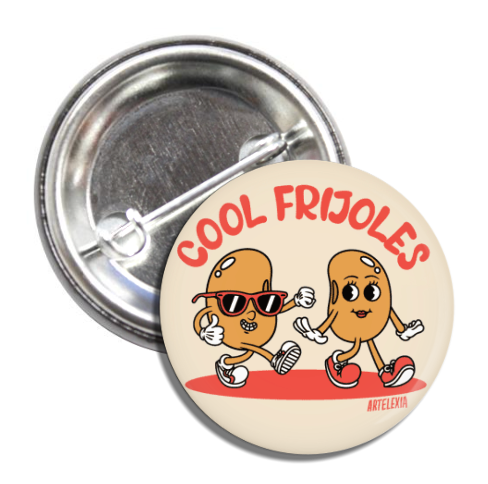 Round pin back button with an illustration of two animated beans and the phrase Cool Frijoles in red lettering