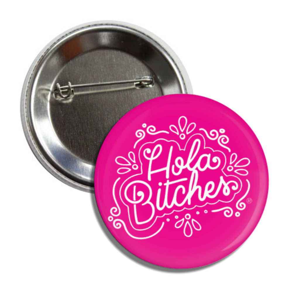 Pink round pin button with the phrase Hola Bitches in white lettering