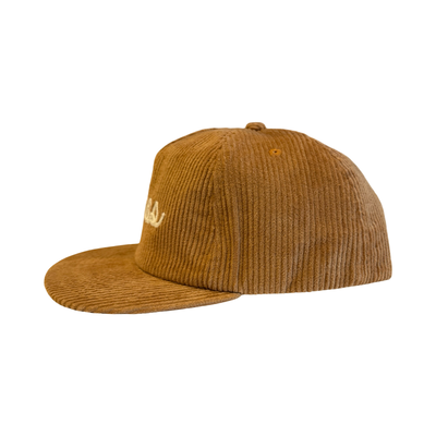 side view of a Orange corduroy hat with the word “Tacos” embroidered in white script on the front.