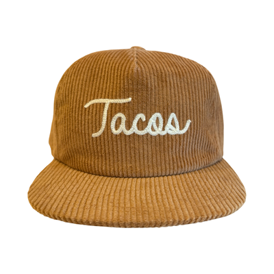 Orange corduroy hat with the word “Tacos” embroidered in white script on the front.