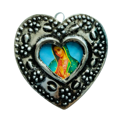 Silver heart-shaped pendant with detailed silver border and central image of the Virgin Mary.