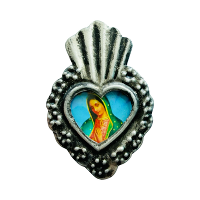 Silver heart-shaped pendant with detailed silver border and central image of the Virgin Mary.
