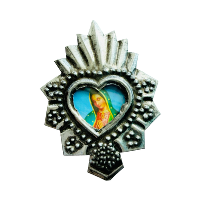 Silver heart-shaped pendant with detailed silver border and central image of the Virgin Mary.