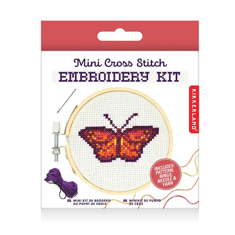 Mini cross stitch embroidery kit featuring a butterfly design on fabric in a hoop, with included yarn and needle shown on the packaging.