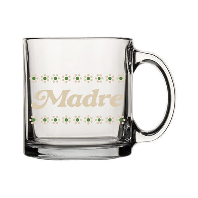 Clear glass mug with phrase "Madre" in ivory lettering. Design also features green flowers with ivory petals