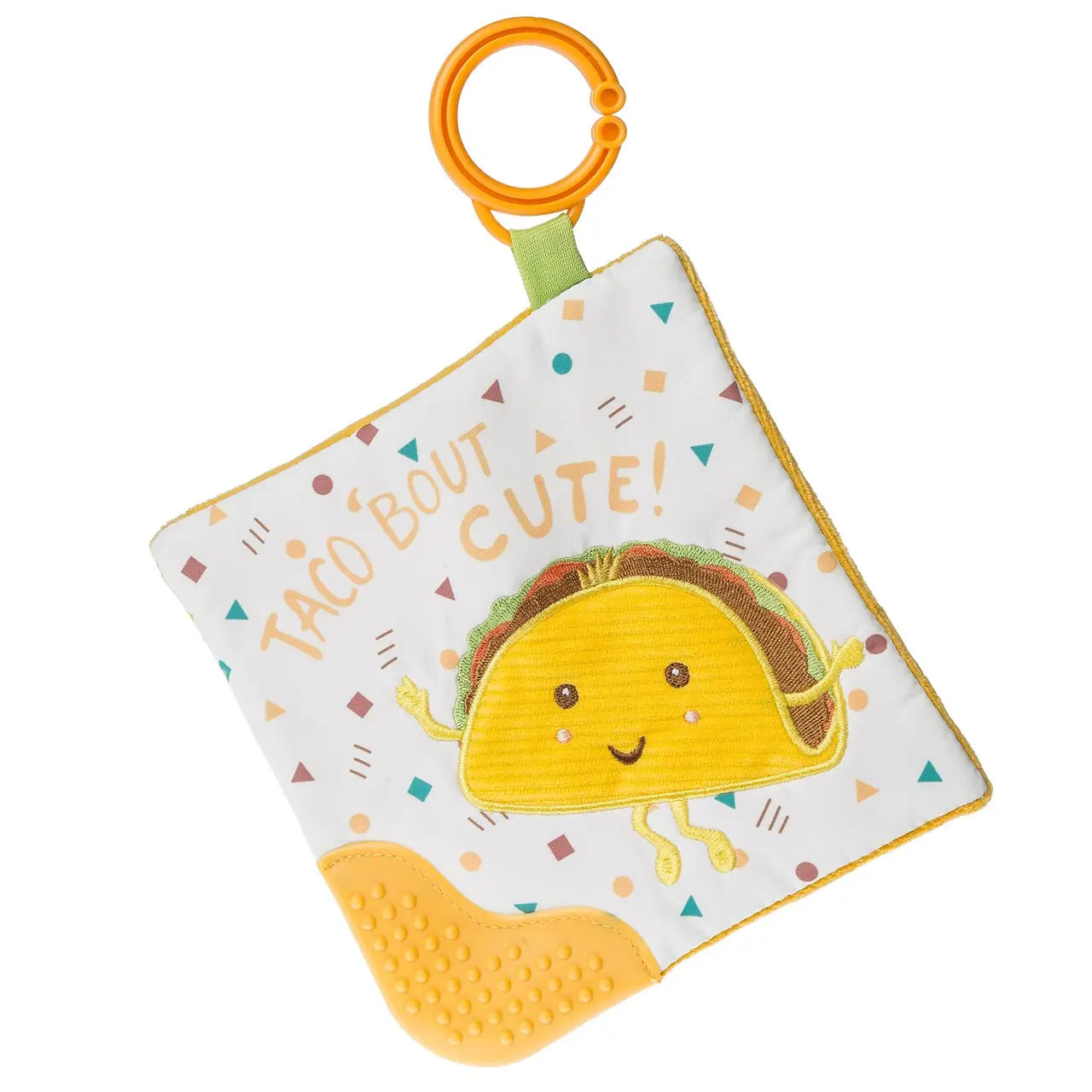 A taco-themed baby teether featuring a crinkly cloth square with colorful confetti patterns, a smiling embroidered taco design, the words "Taco Bout Cute!" in playful font, and a textured yellow teether corner. The teether includes an orange clip ring for attachment.