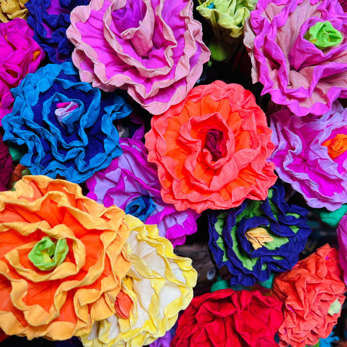 Close up view of a bundle of multi- colored paper flowers