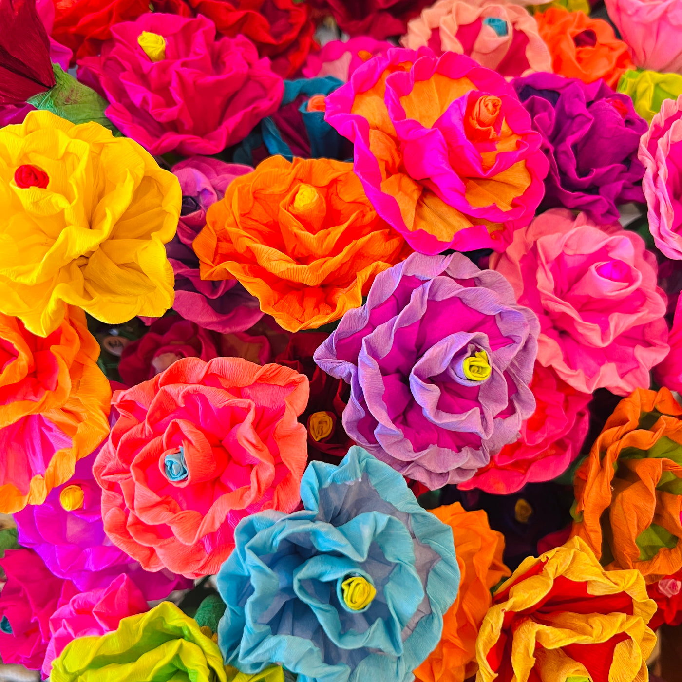 A close up view of a bundle of multi-colored paper flowers