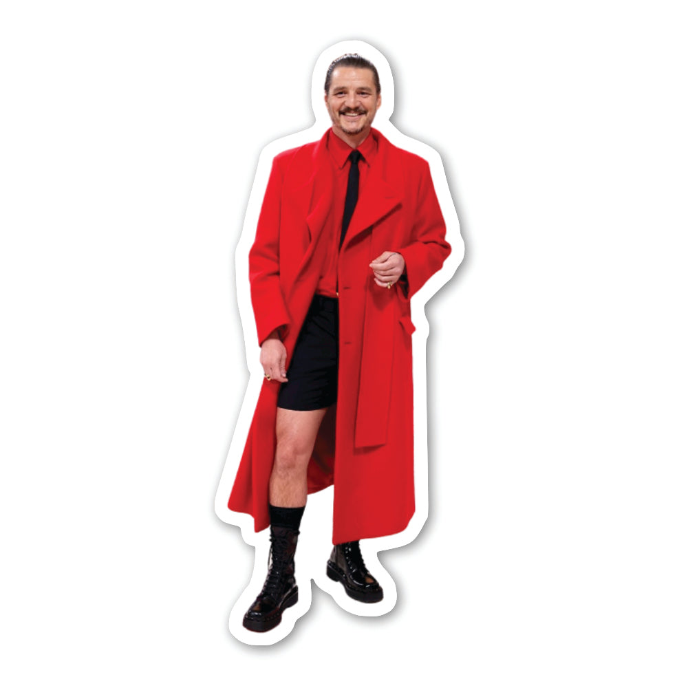 Actor Pedro Pascal in a red trench coat, red shirt and black shorts.