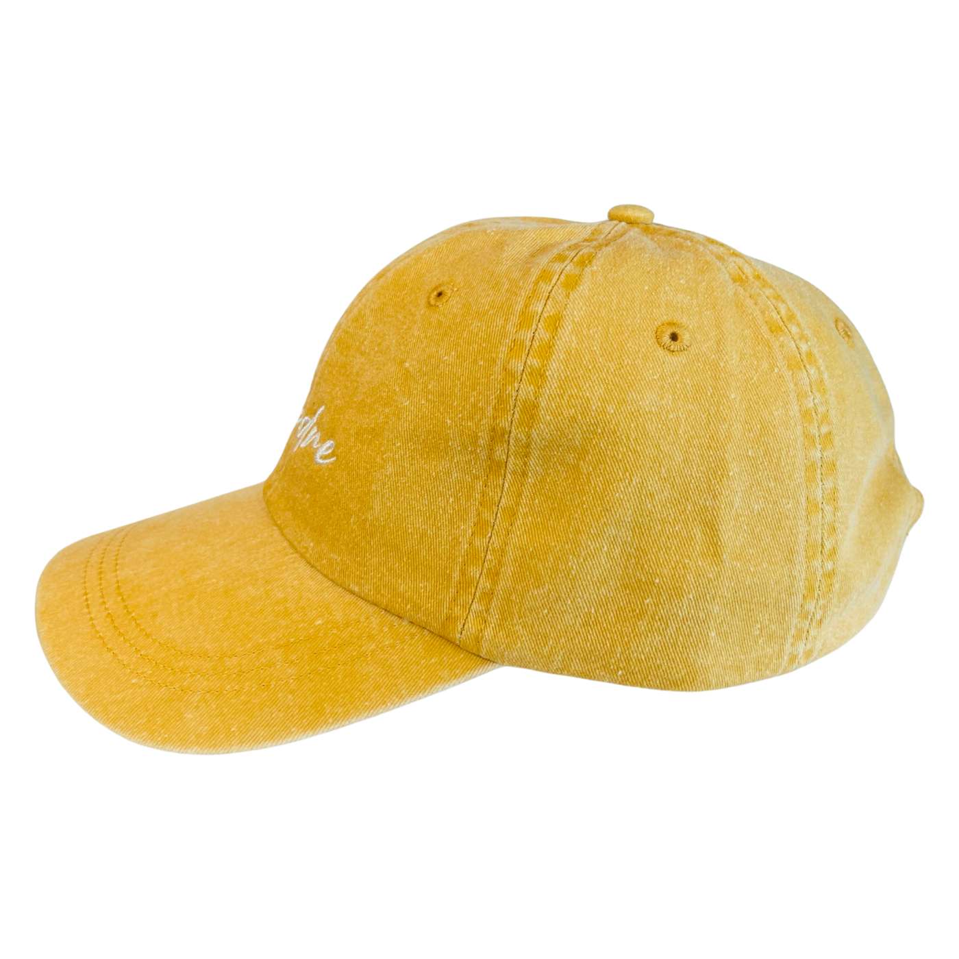 side view of a yellow hat with the word Madre in white lettering