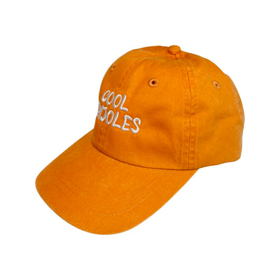 side view of a Orange kid's hat with the phrase Cool Frijoles in white lettering
