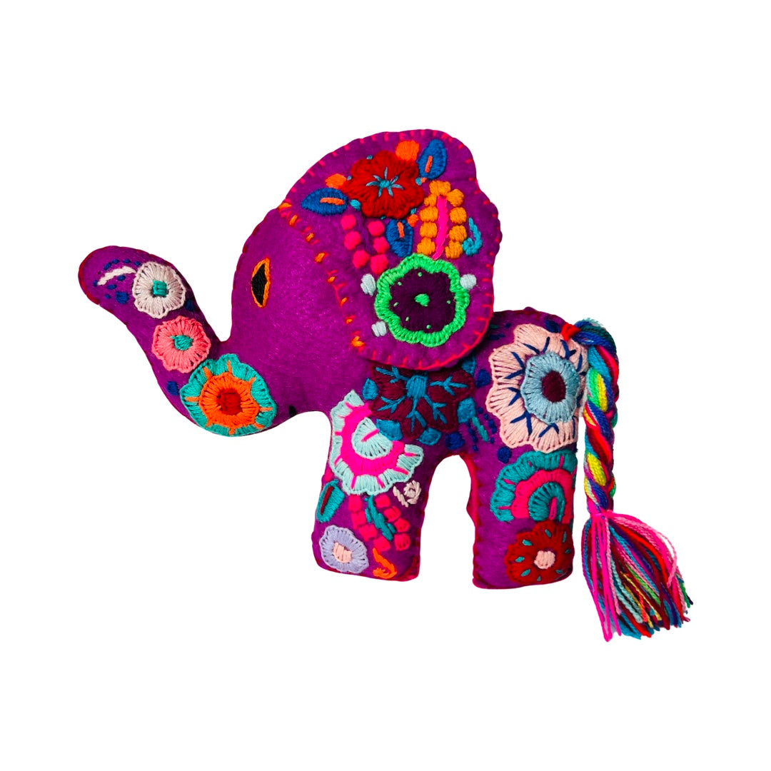 side view of an embroidered fuschia elephant with colorful flowers