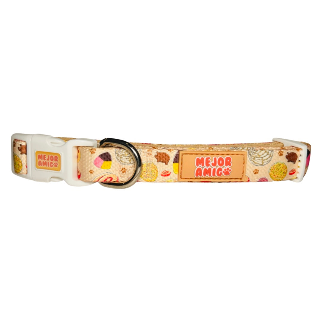 light yellow dog collar with images of pan dulce, a plastic clip and metal D ring.