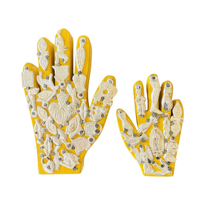 a set of Handmade wooden milagro hands in yellow. Design features a variety of mini milagro charms.
