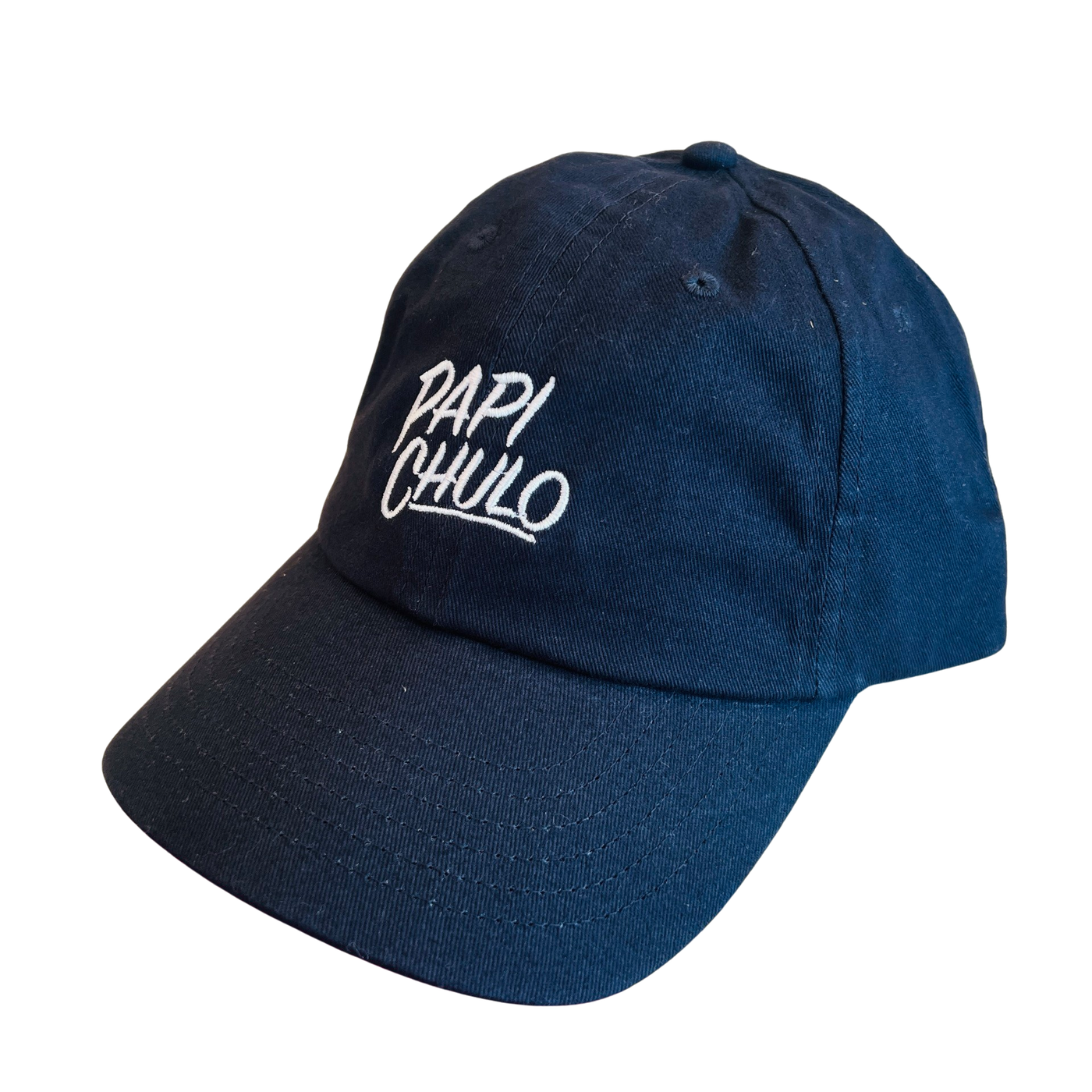 Side view of a dark navy hat with the phrase Papi Chulo in white lettering