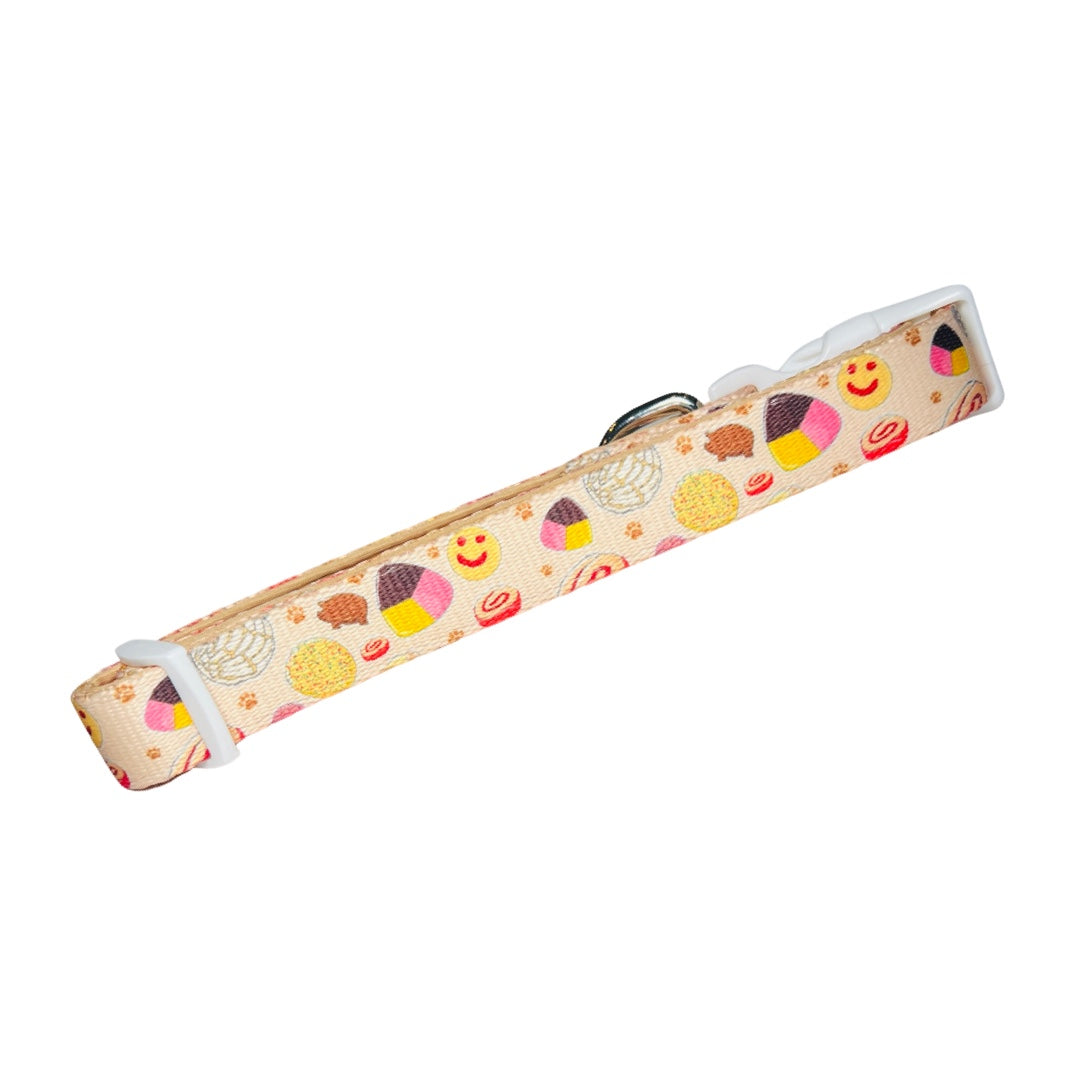 light yellow dog collar with images of pan dulce.