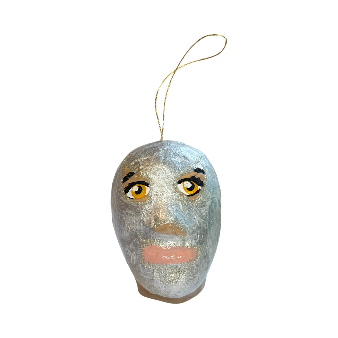Silver paper mache luchador mask ornament with a gold hoop.