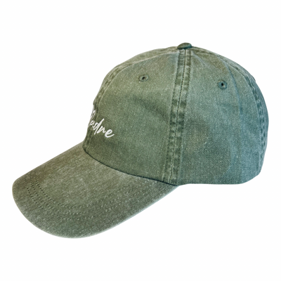 Side view of olive green hat with the word Madre in white lettering