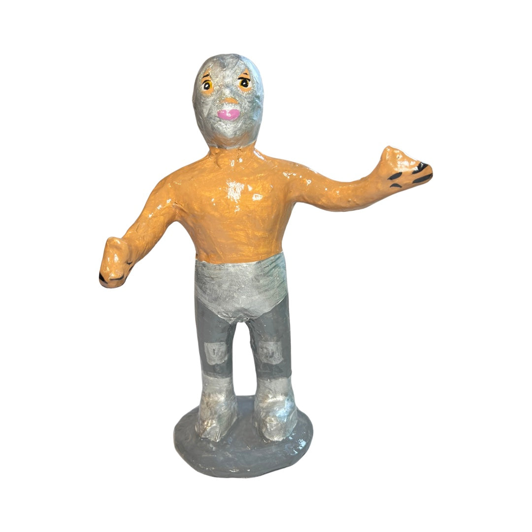 Paper mache Silver full body luchador with a silver mask and briefs and a silver stand.