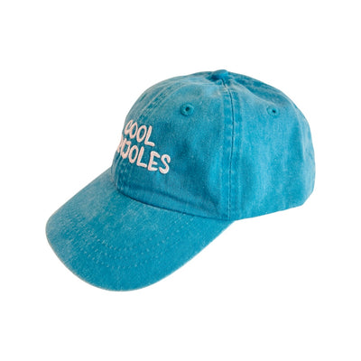 side view of a Turquoise kid's hat with the phrase Cool Frijoles in white lettering