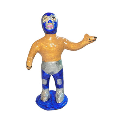 Paper mache full body luchador with blue briefs and mask with a blue stand.