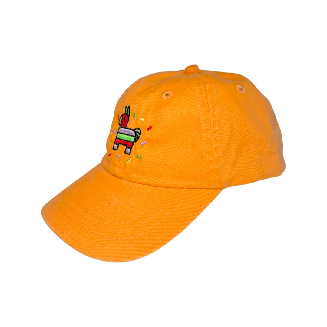side view of a orange kid's hat with an image of a colorful pinata