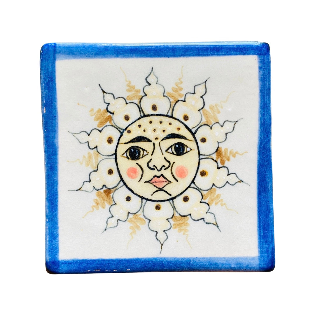 Blue, yellow and white square stoneware coaster with an image of the sun with a smiley face
