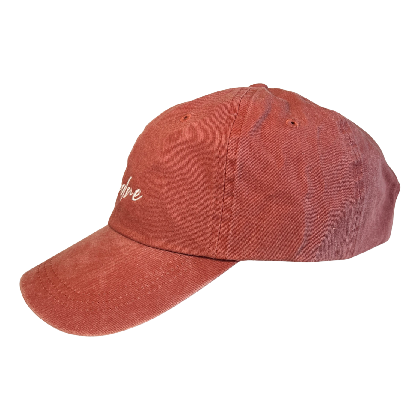 Side view of a coral hat with the word Madre in white lettering
