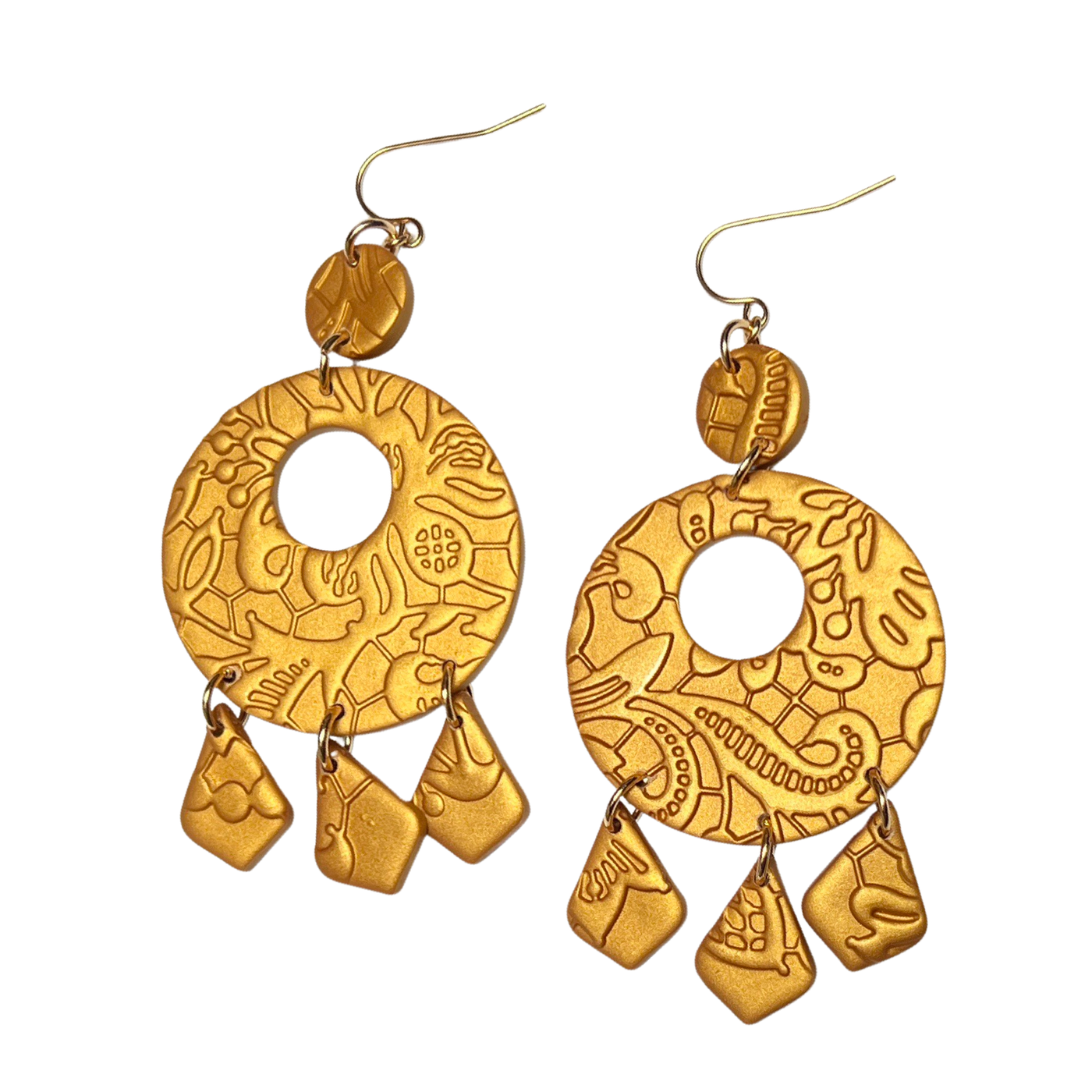 set of gold polymer clay round earrings imprinted with a design and features three dangles.