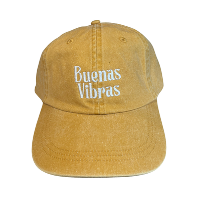 front view of a yellow hat with the phrase Buenas Vibras in white lettering