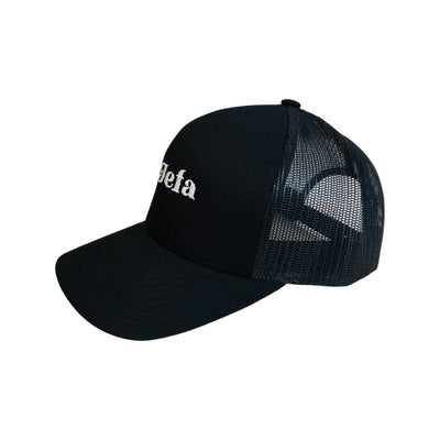 Side view of a Black mesh snap back hat with the phrase La Jefa in white lettering