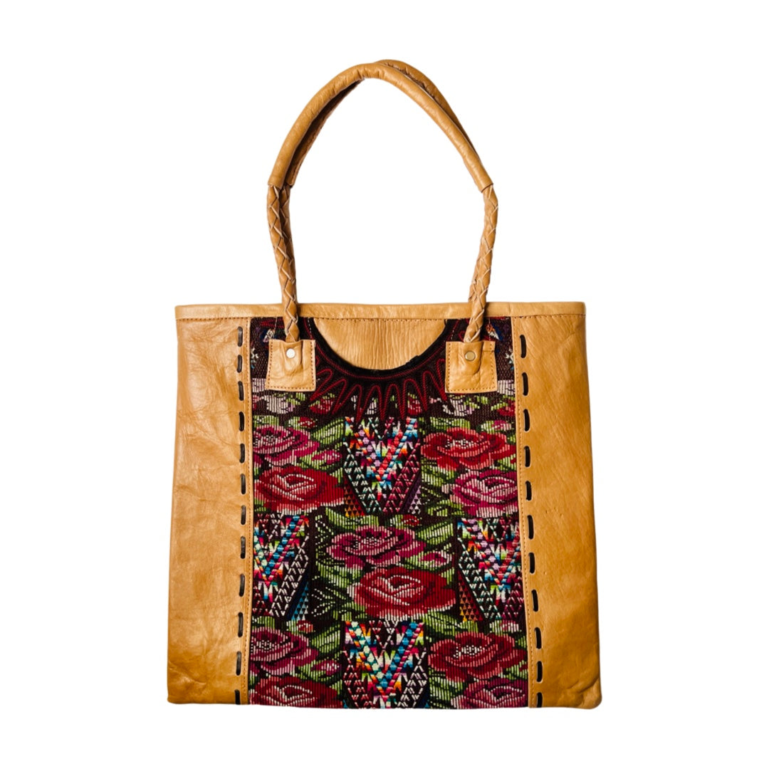Huipile and leather tote bag that features recycled mayan blouse fabric with a flower designand leather handles.