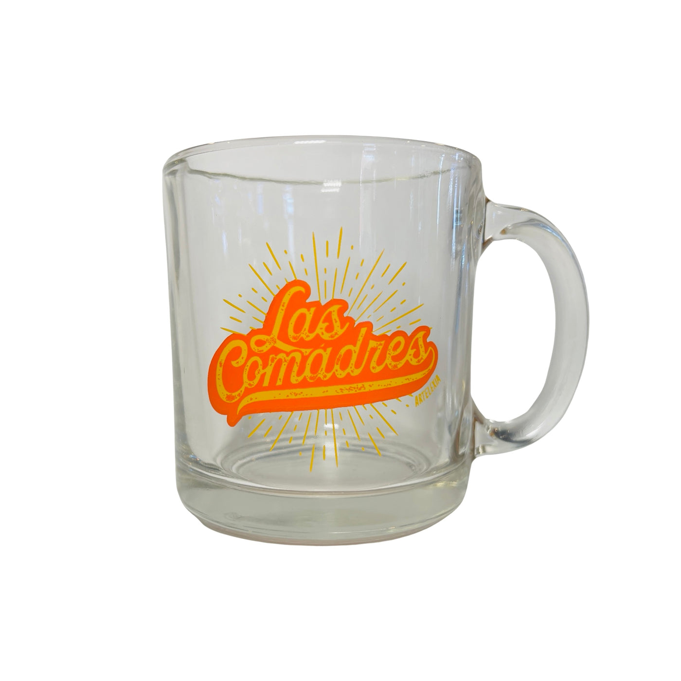 clear glass mug with the phrase Las Comadres in yellow and orange lettering