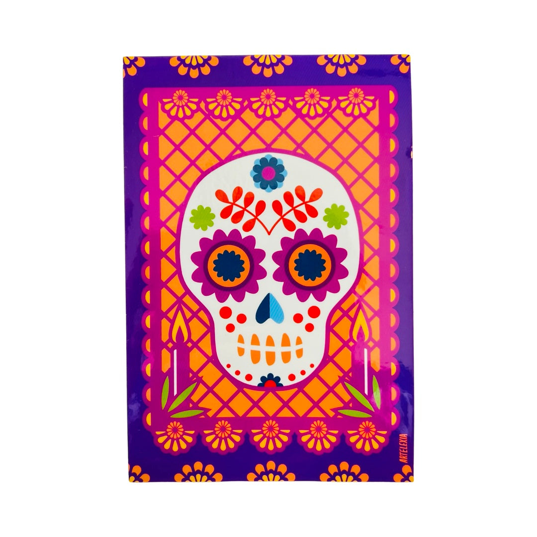 purple rectangle sticker with a pink and orange papel picado design and features a colorful sugar skull in the center.