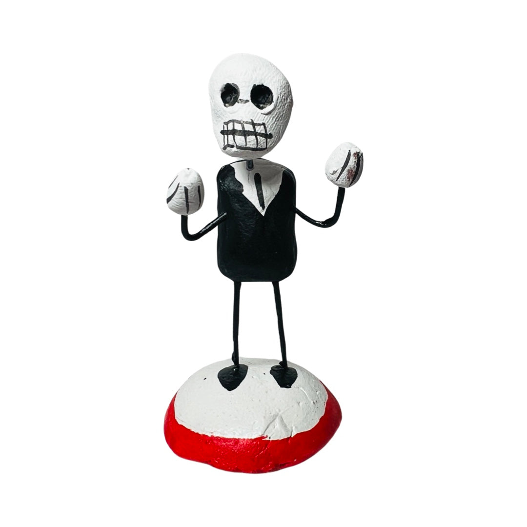 a clay and wire calavera dressed in a suit.