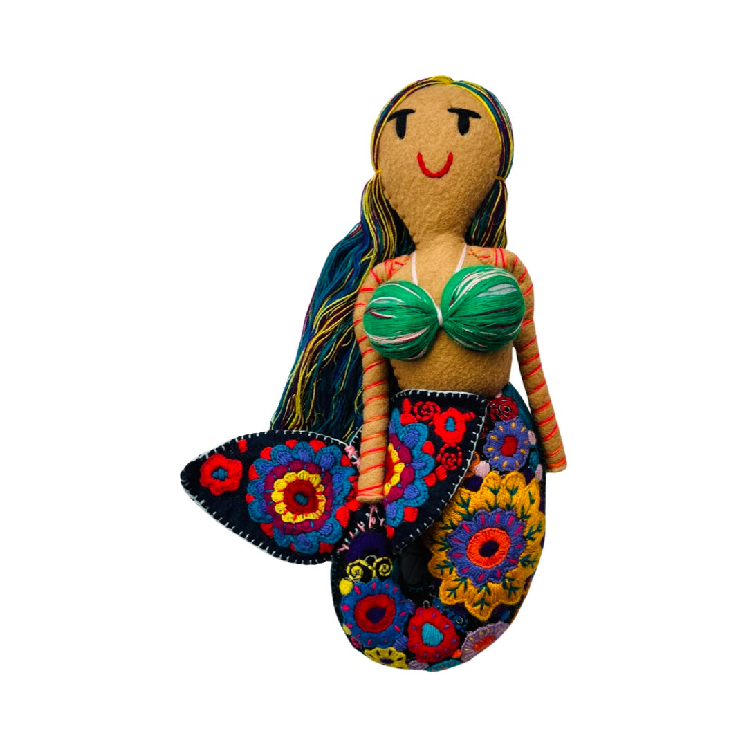 front view of an embroidered mermaid doll that features colorful flowers on her tail.